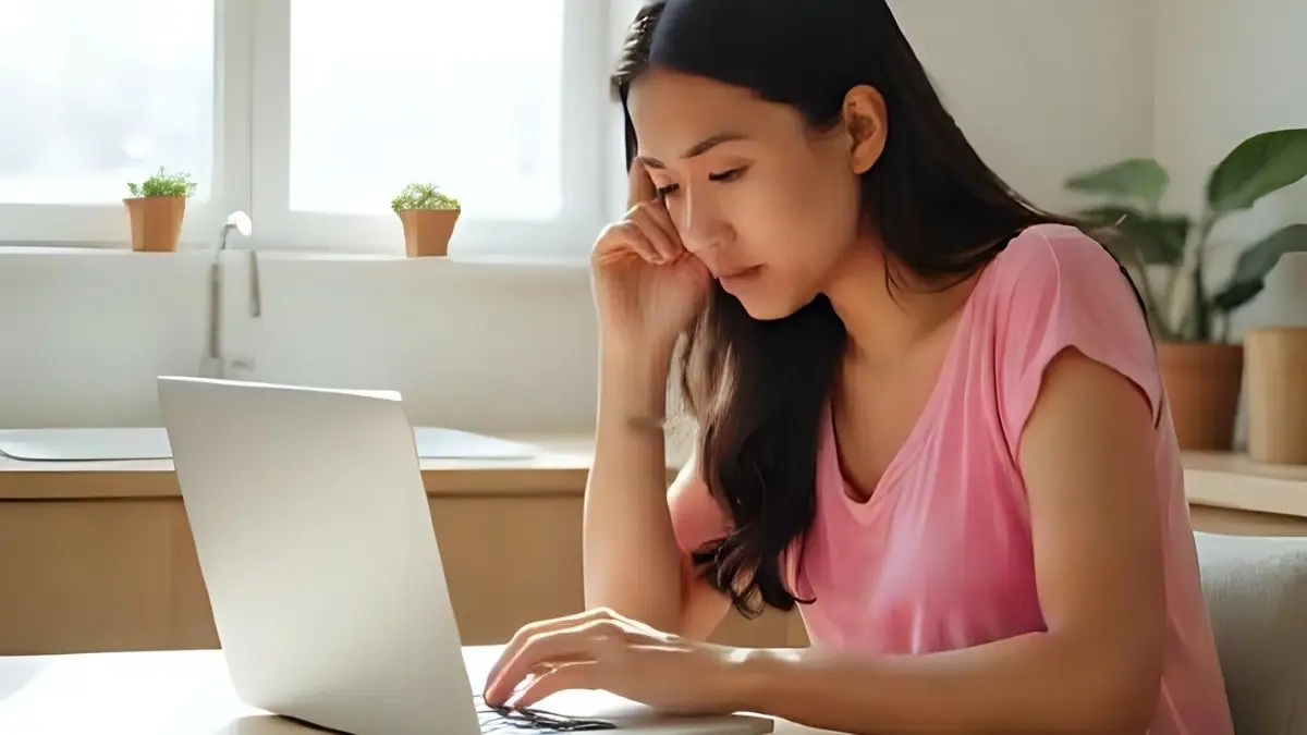 Woman at laptop writing articles for church newsletters